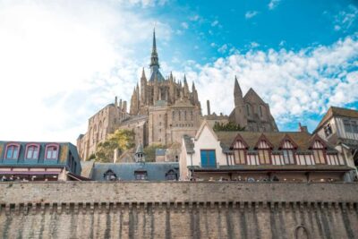 Mont Saint-Michel Small-Group Day Trip from Paris with Abbey Ticket - First sight of Mont Saint-Michel: sand, sky, and a causeway approach