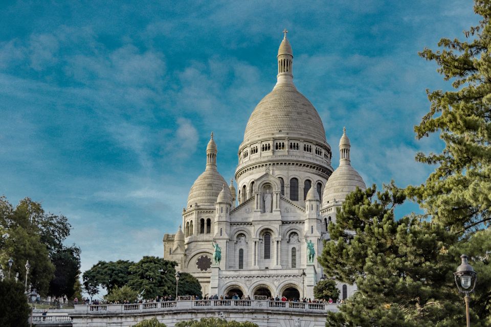 Paris: Charms of Montmartre Guided Walking Tour - The first climb: from Moulin Rouge stories to Amélie and Van Gogh corners