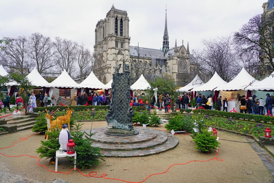 Paris: Christmas Market Guided at Notre Dame & Food Tasting - Notre Dame First: History, Restoration Exhibits, and Photo Angles